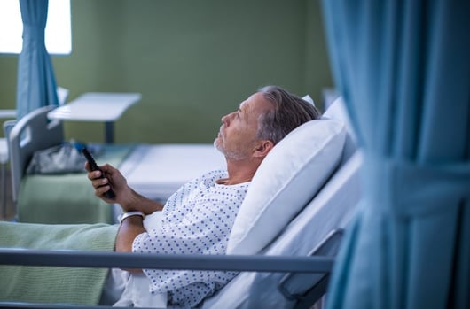 Hospital patient holding TV remote